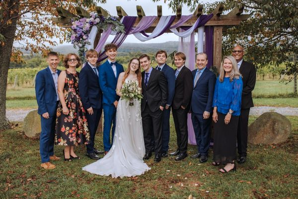 A big family portrait, everyone gathered around Anastasia and Brian.