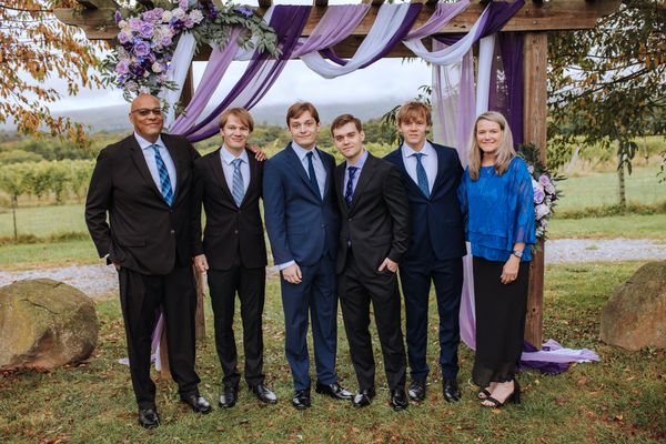 Brian with a group of men and a woman in blue.