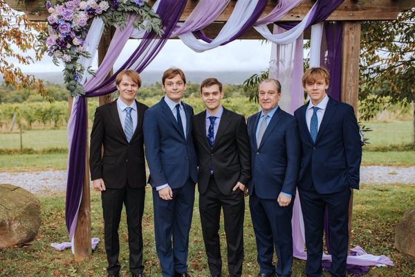 Brian and four young men in navy and black suits.