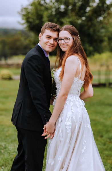 Cheek to cheek, the newlyweds smile for the camera.