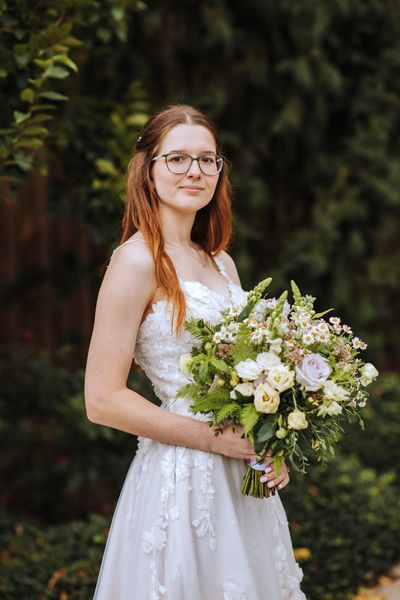 A soft, close portrait of Anastasia among the greenery.