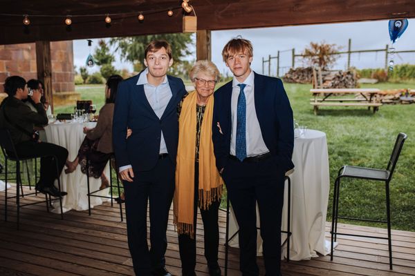 Three guests pose together on the pavilion deck.