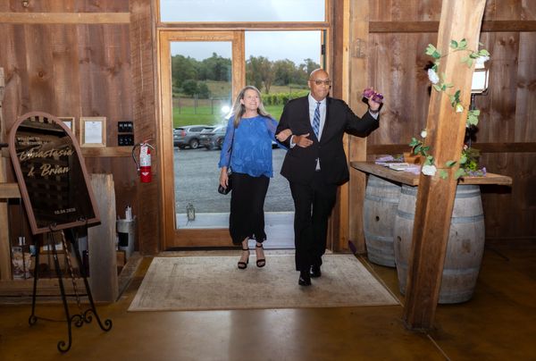 A couple makes a grand entrance into the barn.