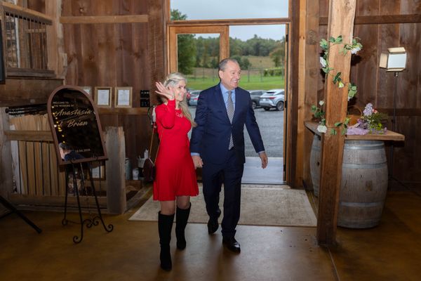 A woman in red and her partner make their entrance.