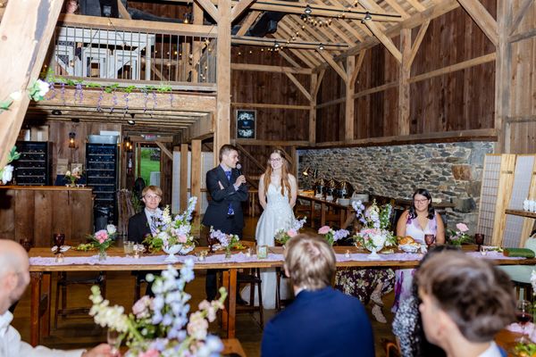 The whole barn turns toward the head table for the toasts.