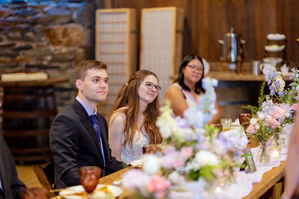 The newlyweds listen from the head table.