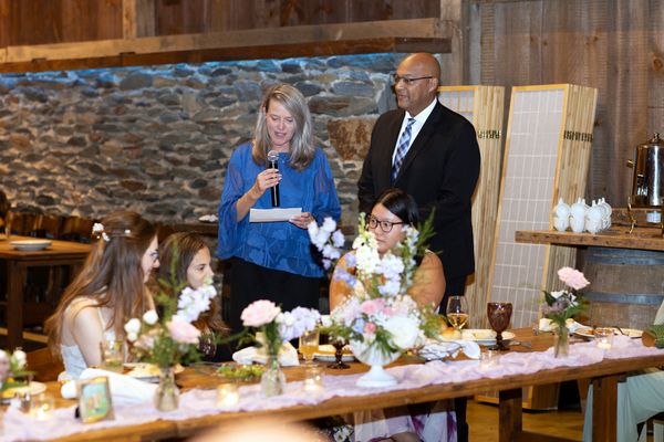 A woman in blue gives her toast.