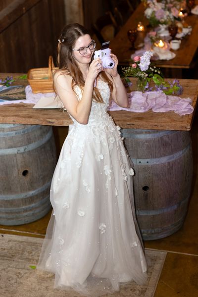 The bride takes a sip from her cup.