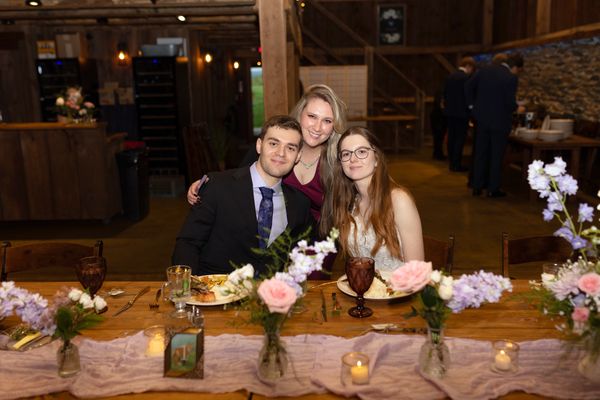 The newlyweds visit a table of guests.