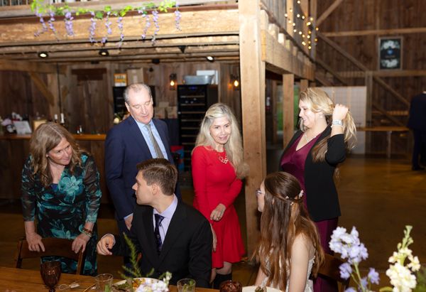 A table of guests poses with Anastasia and Brian.