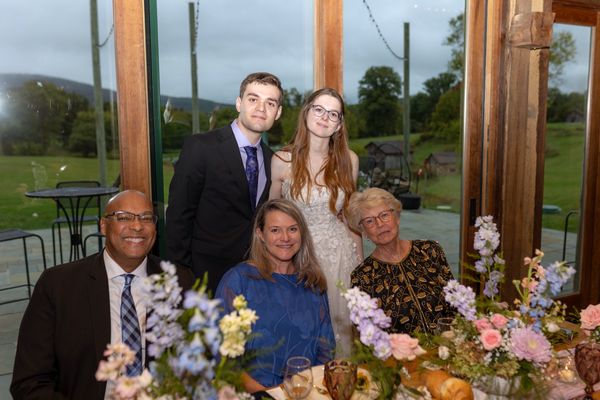Guests by the window pose with the couple.