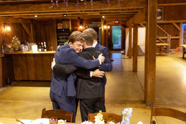 Two guests share a warm hug.